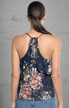 Navy floral asymmetrical ruffle tank top with adjustable straps, front layers, and an open tie-back detail.