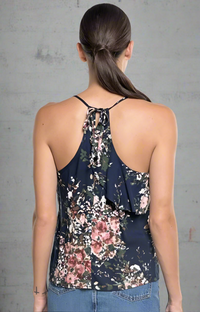 Navy floral asymmetrical ruffle tank top with adjustable straps, front layers, and an open tie-back detail.
