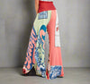 Colorful wide-leg pants with mixed patterns, crystal embellishments, and gathered waist ties, styled with a red crop top