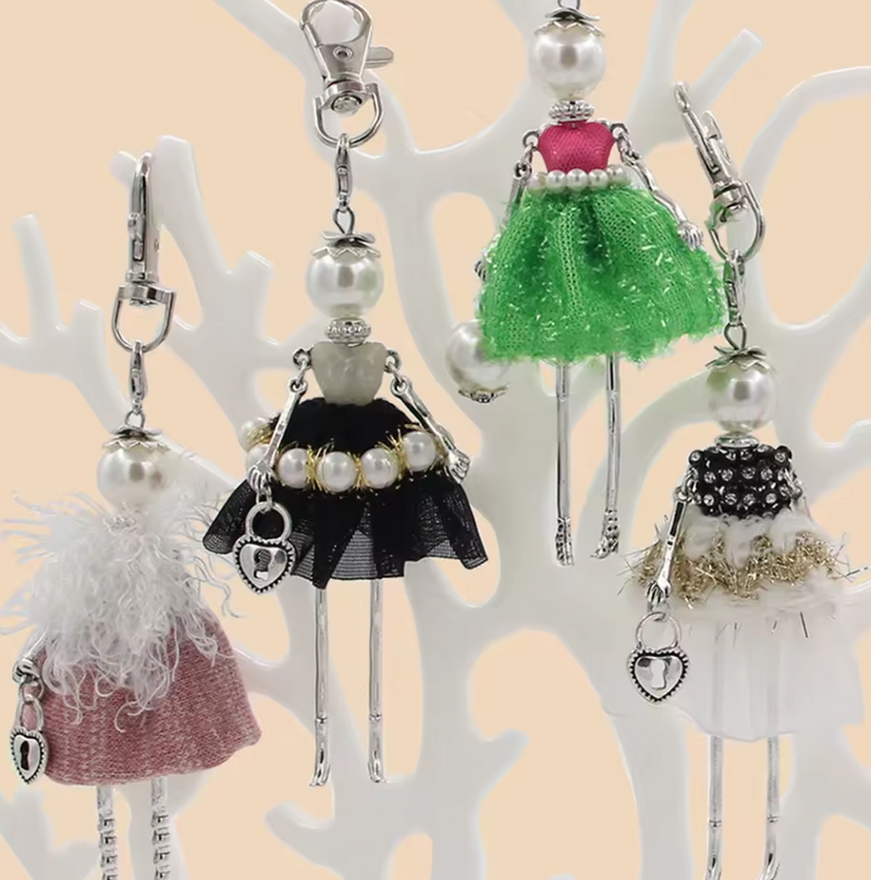 Assorted Chic Lady keychains featuring fashion doll designs with pearl accents, fabric skirts, and metallic details.