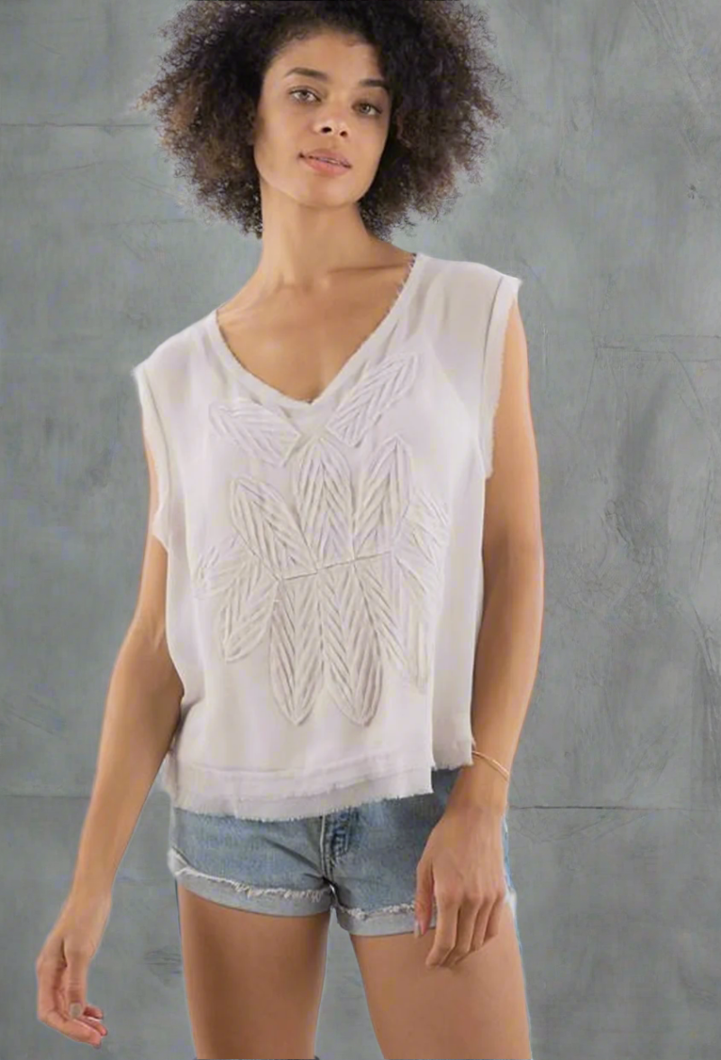 stone color chiffon sleeveless top with floral appliqué detail and raw edges, styled with a relaxed fit and under cami.