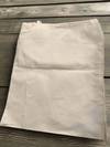 A cotton muslin drawstring dust bag on a wooden table