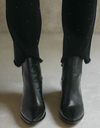 Close-up of raw frayed hems on black rhinestone-studded jeans paired with black pointed-toe ankle boots







Close-up of raw frayed hems on black rhinestone-studded jeans paired with black pointed-toe ankle boots








