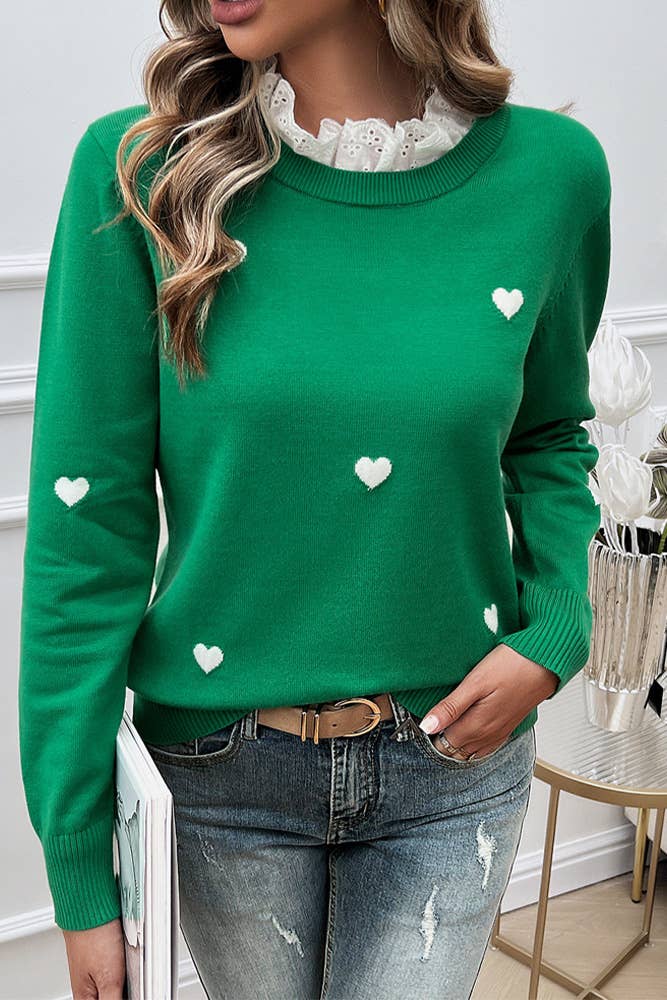 A chic emerald green sweater with embroidered white hearts and a delicate lace ruffled collar, perfect for a feminine and stylish look.