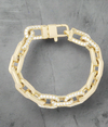 Gold chunky chain bracelet with pavé diamond links and clasp, styled in a circular layout