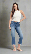 Woman wearing high-rise cropped jeans with scalloped raw hems, styled with a white tank top and sandals