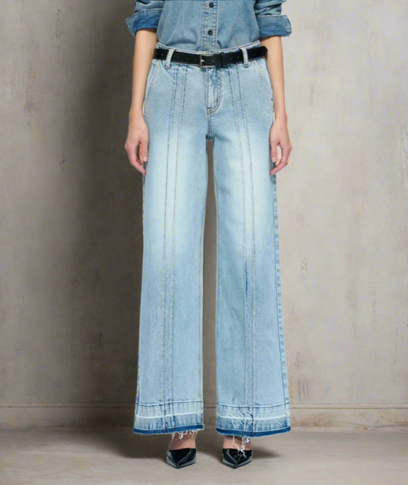 Woman wearing light blue wide-leg jeans with double front seam stitching, raw hems, and a black belt