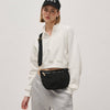 Eco-friendly woven crossbody bag made from recycled materials, featuring an adjustable strap and secure zipper compartments for hands-free convenience.

