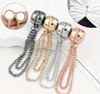 A set of four magnetic clothing clips with chain details, available in black, gold, silver, and rose gold. Designed for securing scarves, shawls, or cinching fabric for a polished look.

