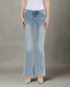 Woman wearing low-rise light wash mini flare jeans with a finished hem and natural fade, paired with silver heels