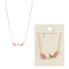 Retro-style golf necklace featuring pink enamel letters spelling "GOLF," a textured golf ball charm, and a gold-tone golf club accent on a delicate chain.