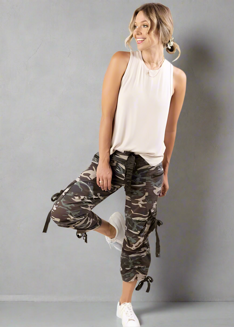 Camo capri cargo pants with adjustable ties and mid-rise relaxed fit, featuring multiple pockets and cropped length.
