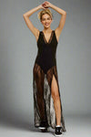 Model wearing a black lace overlay bodysuit dress, featuring a deep V-neckline, sleeveless bodysuit, and sheer lace maxi overlay with front slits.