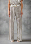 Silver full-length pleated pants with a relaxed fit and elastic waistband, styled with a white belt and heels