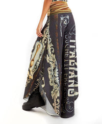 Black wide-leg pants with vintage Italian restaurant text print and rhinestone embellishments, styled with neutral wrap top