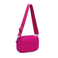 A sleek fuchsia woven neoprene crossbody bag with an adjustable strap, styled for a casual yet chic look.

