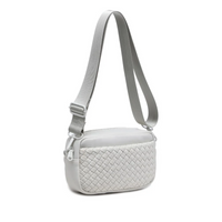 A sleek bone color woven neoprene crossbody bag with an adjustable strap, styled for a casual yet chic look.

