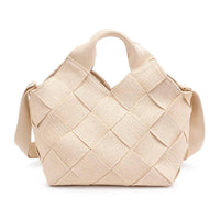 A woven straw tote bag in a chic, summery design, featuring gold hardware and an adjustable strap, perfect for vacation and warm-weather styling.