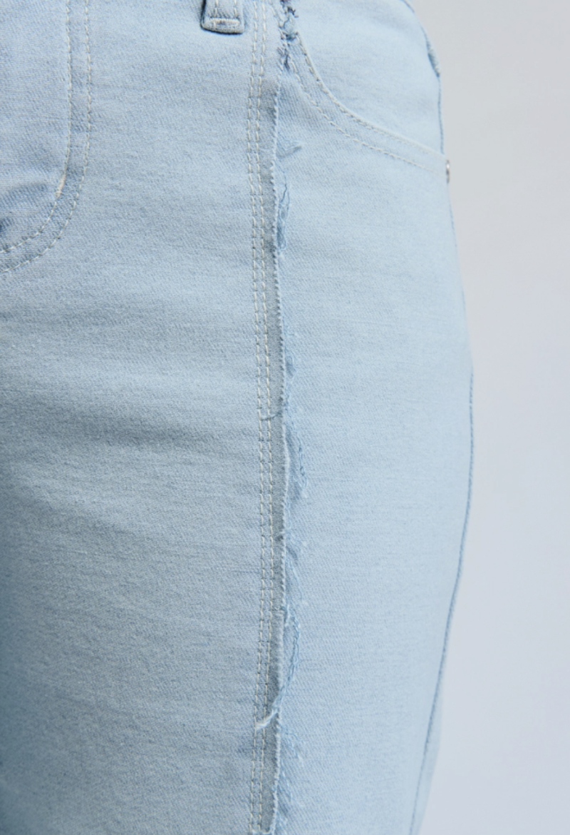 exposed frayed seams of wide-leg denim jeans